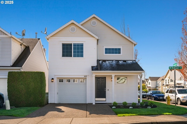 traditional-style house featuring a garage and driveway