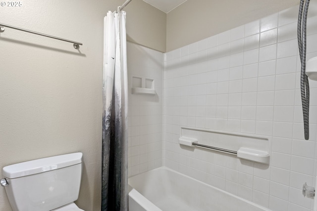 bathroom with shower / bath combo and toilet