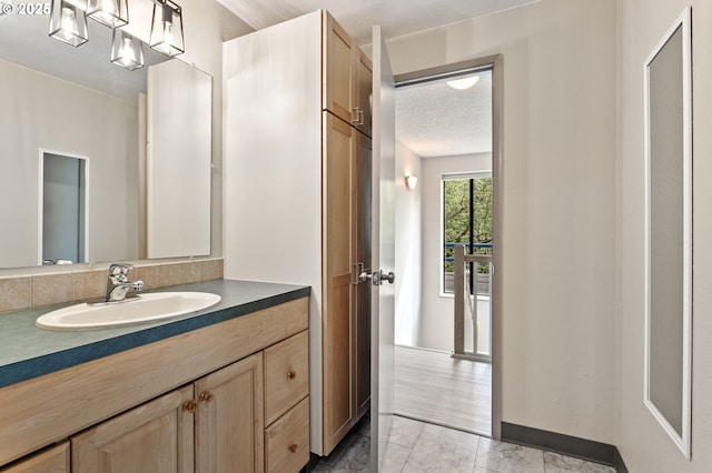 bathroom featuring a textured ceiling and vanity
