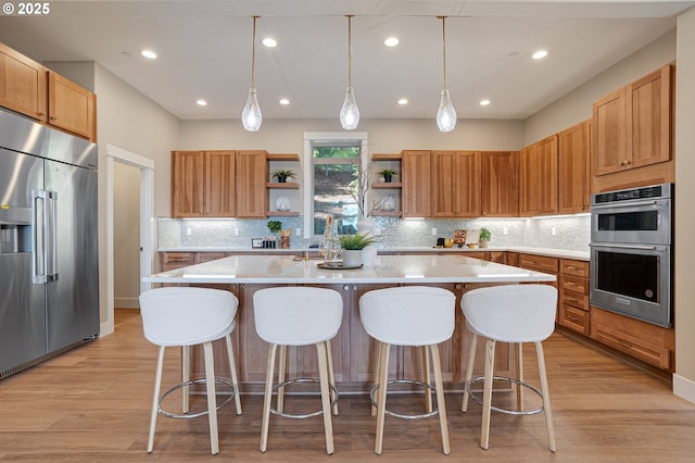 14 Juarez St, Lake Oswego, OR 97035 - kitchen with appliances with stainless steel finishes, open shelves, light countertops, decorative backsplash, and a kitchen bar