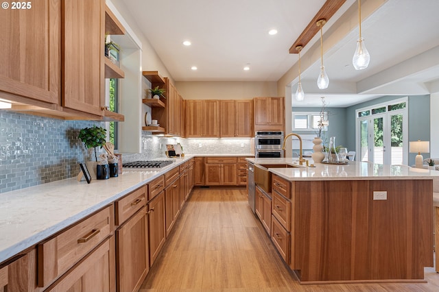14 Juarez St, Lake Oswego, OR 97035 - kitchen with open shelves, light wood-type flooring, a sink, light stone countertops, and a kitchen island with sink