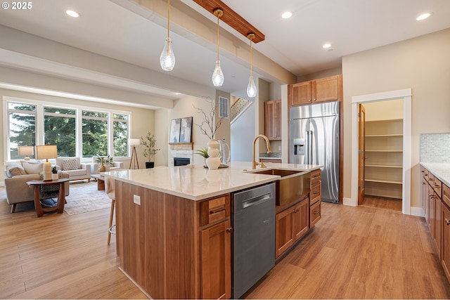 14 Juarez St, Lake Oswego, OR 97035 - kitchen featuring stainless steel appliances, a sink, open floor plan, light wood-style floors, and recessed lighting