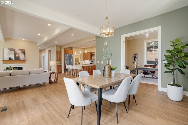 14 Juarez St, Lake Oswego, OR 97035 - dining space with light wood-style floors, a chandelier, recessed lighting, baseboards, and a fireplace