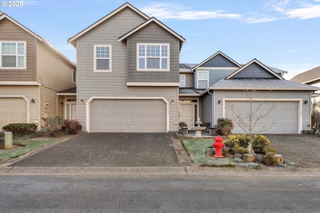 view of front facade featuring driveway and a shingled roof