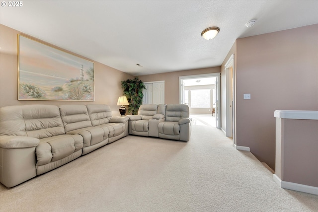 carpeted living area with baseboards