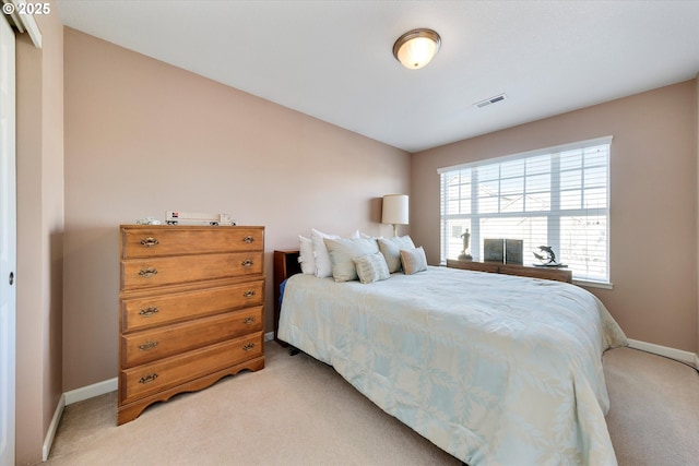 bedroom with visible vents, light colored carpet, and baseboards