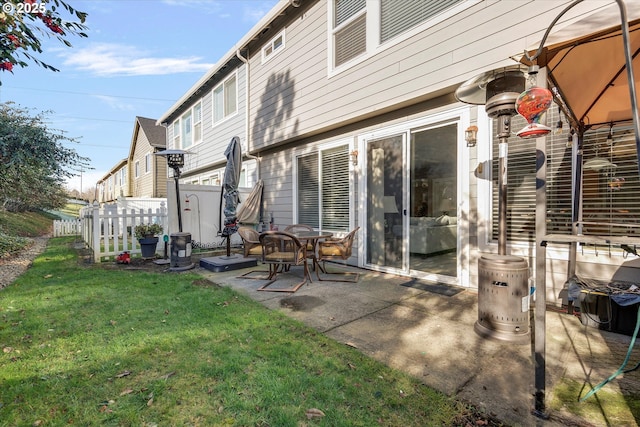 back of property featuring a yard, a patio, and fence