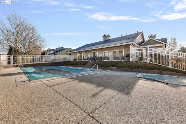 view of swimming pool with a patio area, a fenced in pool, and fence