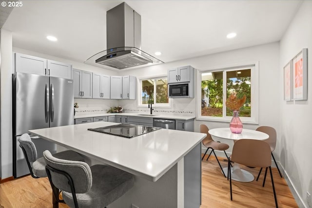 4819 SW Hamilton St, Portland, OR 97221 - kitchen with range hood, black appliances, light countertops, gray cabinetry, and recessed lighting