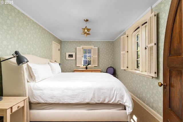 bedroom with crown molding and wallpapered walls