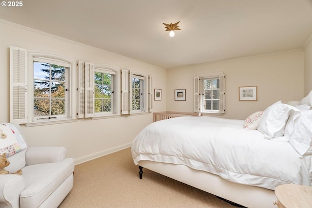 carpeted bedroom featuring baseboards and ornamental molding