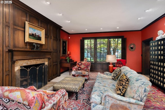 living area featuring crown molding, recessed lighting, and a fireplace