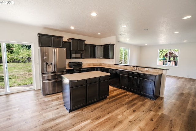 24823 Hawks View Dr, Veneta, OR 97487 - kitchen featuring black appliances, healthy amount of natural light, a center island, recessed lighting, and a peninsula