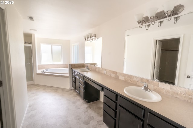 24823 Hawks View Dr, Veneta, OR 97487 - full bathroom with double vanity, a garden tub, a shower stall, and backsplash