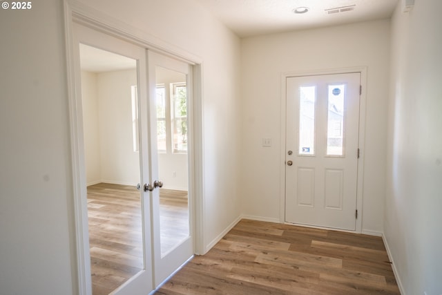 24823 Hawks View Dr, Veneta, OR 97487 - doorway with healthy amount of natural light, wood finished floors, and french doors