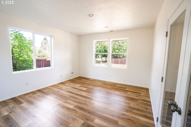 24823 Hawks View Dr, Veneta, OR 97487 - empty room featuring wood finished floors, a textured ceiling, and recessed lighting