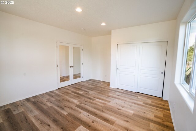 24823 Hawks View Dr, Veneta, OR 97487 - unfurnished bedroom featuring french doors, wood finished floors, recessed lighting, and a closet
