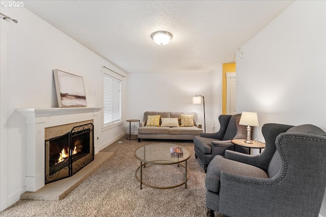 carpeted living area with baseboards, a warm lit fireplace, and a textured ceiling