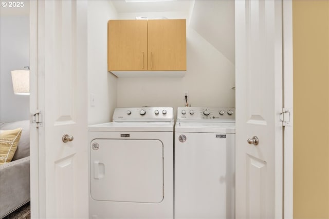 washroom featuring cabinet space and washer and dryer