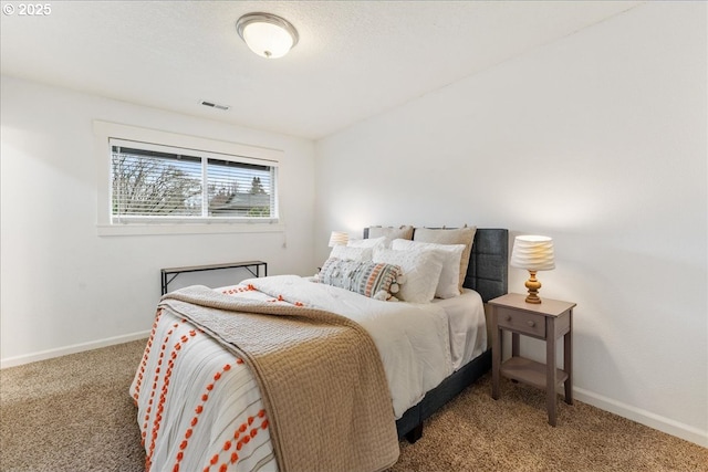 carpeted bedroom with visible vents and baseboards