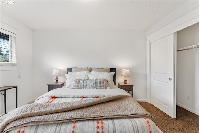 carpeted bedroom featuring baseboards