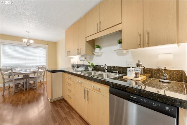 kitchen with wood finished floors, light brown cabinetry, a sink, tile counters, and stainless steel dishwasher