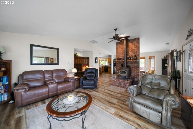 33817 Gage Rd, Mitchell, OR 97750 - living room with a wood stove, lofted ceiling, wood finished floors, and a ceiling fan