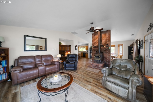 33817 Gage Rd, Mitchell, OR 97750 - living room featuring a wood stove, vaulted ceiling, wood finished floors, and ceiling fan