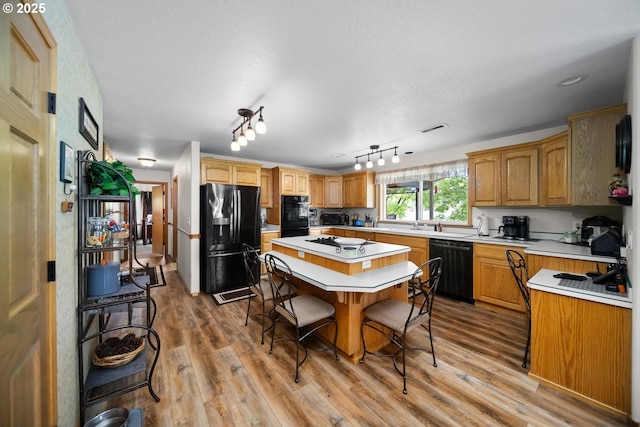 33817 Gage Rd, Mitchell, OR 97750 - kitchen with black appliances, light countertops, and light wood-style floors