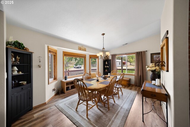 33817 Gage Rd, Mitchell, OR 97750 - dining area with a chandelier, light wood-style flooring, lofted ceiling, and baseboards