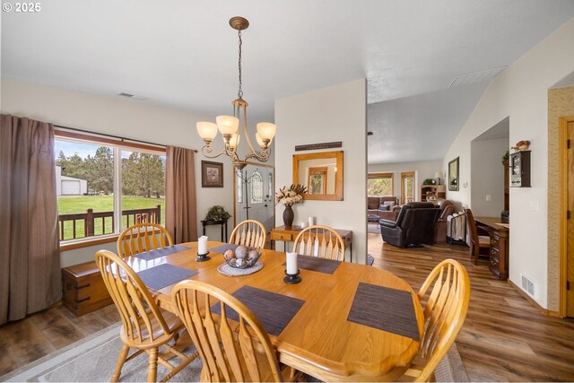 33817 Gage Rd, Mitchell, OR 97750 - dining area featuring wood finished floors, a chandelier, and plenty of natural light