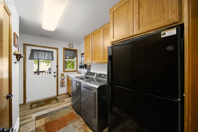 33817 Gage Rd, Mitchell, OR 97750 - laundry area featuring cabinet space, washer and dryer, and wood finished floors