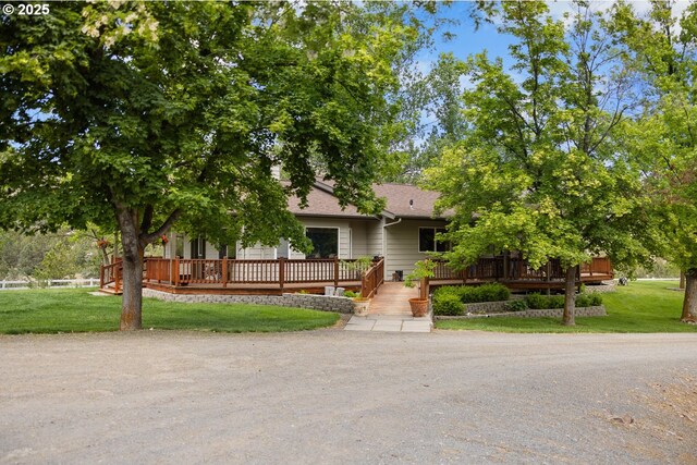 33817 Gage Rd, Mitchell, OR 97750 - view of property hidden behind natural elements featuring a deck, a front yard, and roof with shingles