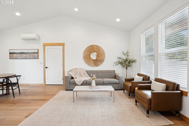 16000 NE Grantham Rd, Amboy, WA 98601 - living room featuring lofted ceiling, light wood finished floors, a wall unit AC, recessed lighting, and baseboards