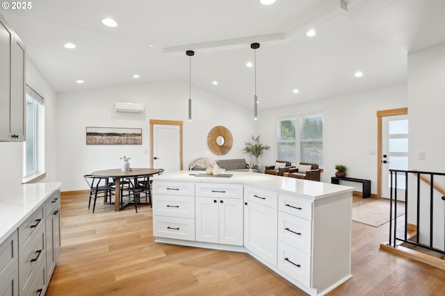 16000 NE Grantham Rd, Amboy, WA 98601 - kitchen featuring lofted ceiling, light wood-type flooring, a wall mounted AC, hanging light fixtures, and recessed lighting