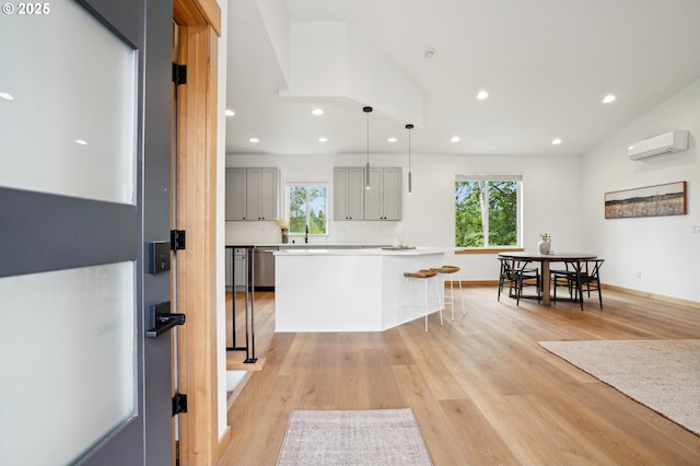 16000 NE Grantham Rd, Amboy, WA 98601 - kitchen featuring stainless steel dishwasher, gray cabinetry, an AC wall unit, recessed lighting, and a kitchen breakfast bar