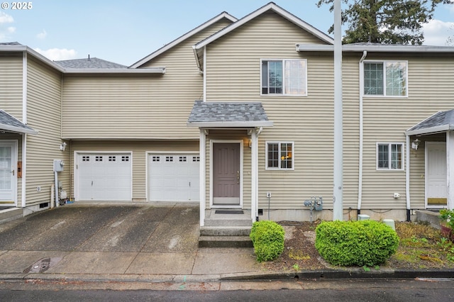 townhome / multi-family property featuring concrete driveway and an attached garage