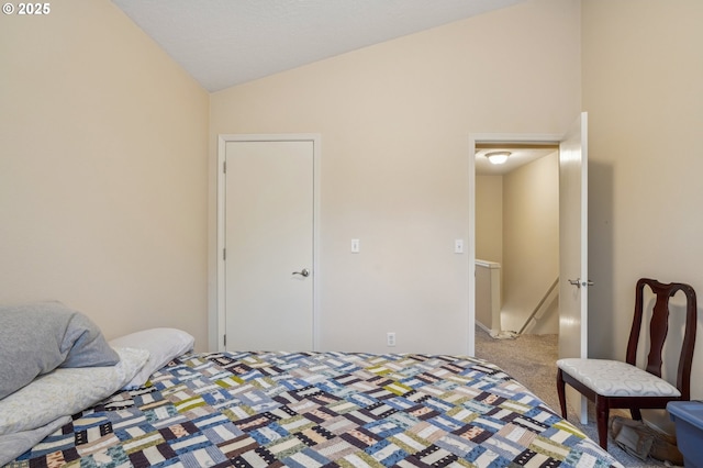 carpeted bedroom featuring lofted ceiling