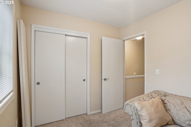 bedroom with carpet floors and a closet