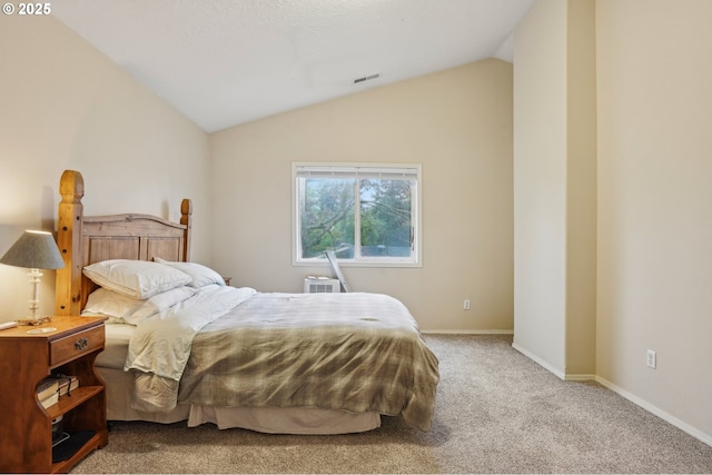 bedroom featuring carpet, lofted ceiling, and baseboards