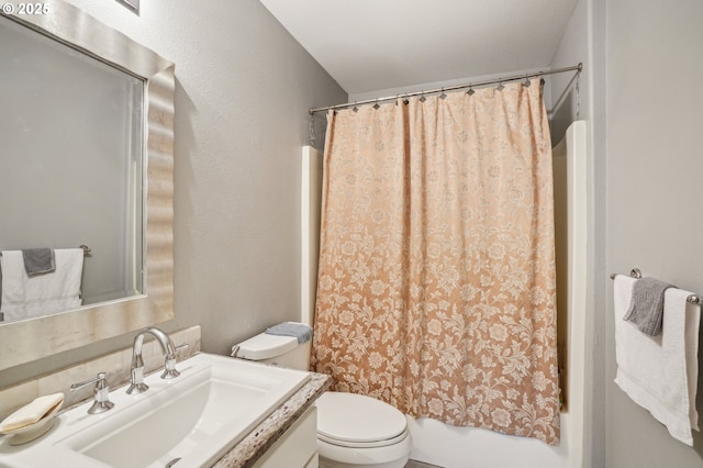 full bath featuring toilet, shower / bath combination with curtain, vanity, and a textured wall
