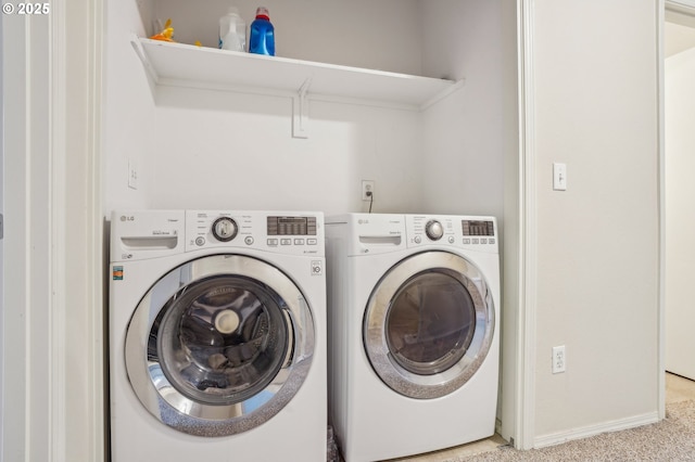 laundry area with washer and dryer and carpet