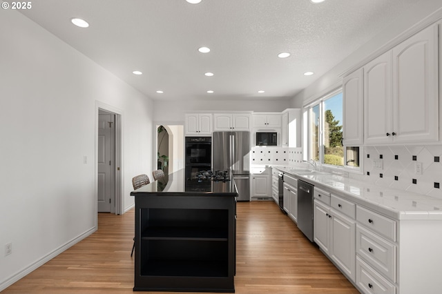 14405 NW Valley View Ln, Portland, OR 97231 - kitchen featuring black appliances, open shelves, a sink, white cabinetry, and decorative backsplash