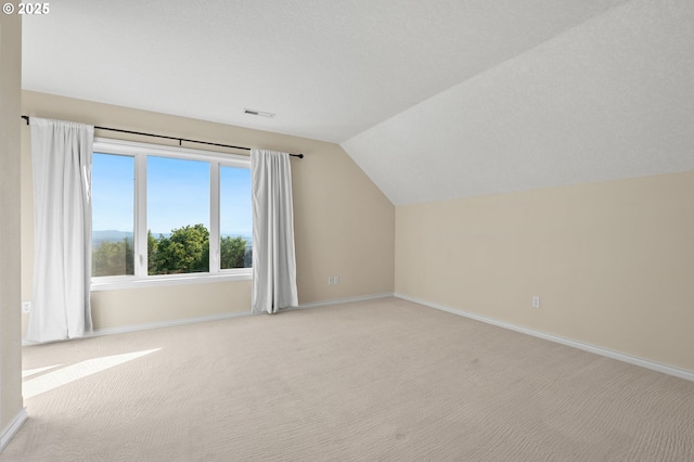 14405 NW Valley View Ln, Portland, OR 97231 - additional living space featuring lofted ceiling, light carpet, and baseboards