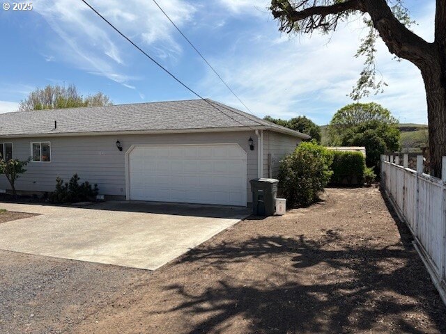 3202 NE Riverside Ave, Pendleton, OR 97801 - view of home's exterior featuring fence and a garage