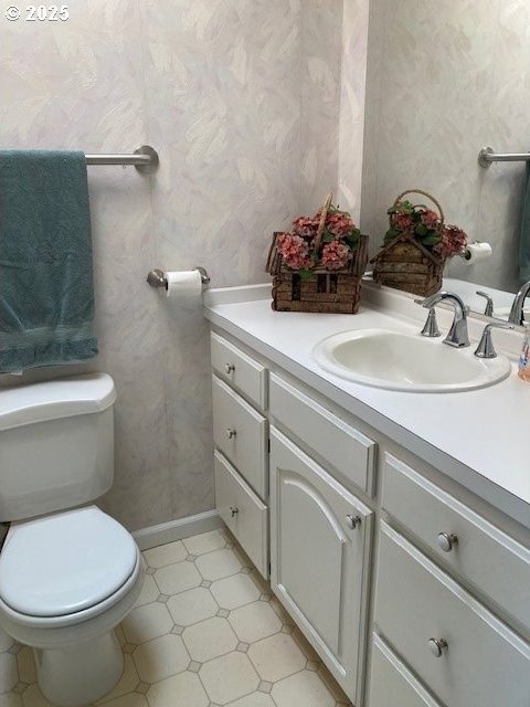 3202 NE Riverside Ave, Pendleton, OR 97801 - half bathroom with wallpapered walls, vanity, and toilet