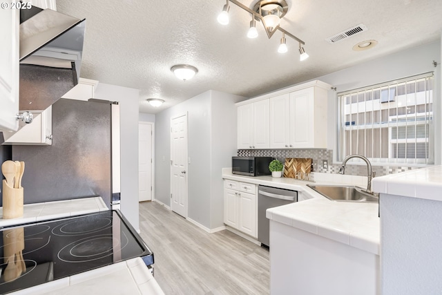 20551 SW Tesoro Ct, Beaverton, OR 97003 - kitchen featuring dishwasher, a sink, light wood-style flooring, range with electric cooktop, and tile counters