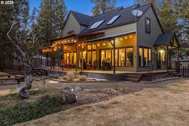 back of house with a wooden deck