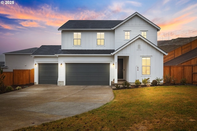 view of front of home featuring a garage and a lawn