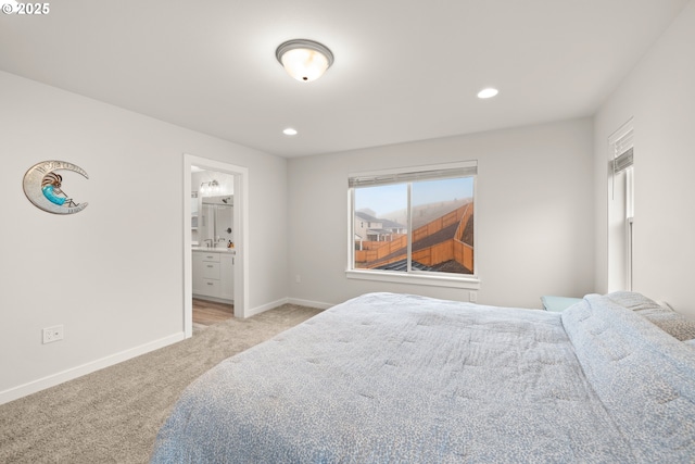 bedroom with light carpet and ensuite bathroom